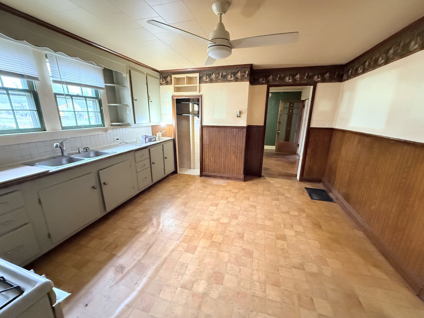820 South 10th Street Herrin, IL 62948 - Photo 8 of 15 a large white kitchen with a sink a refrigerator and window