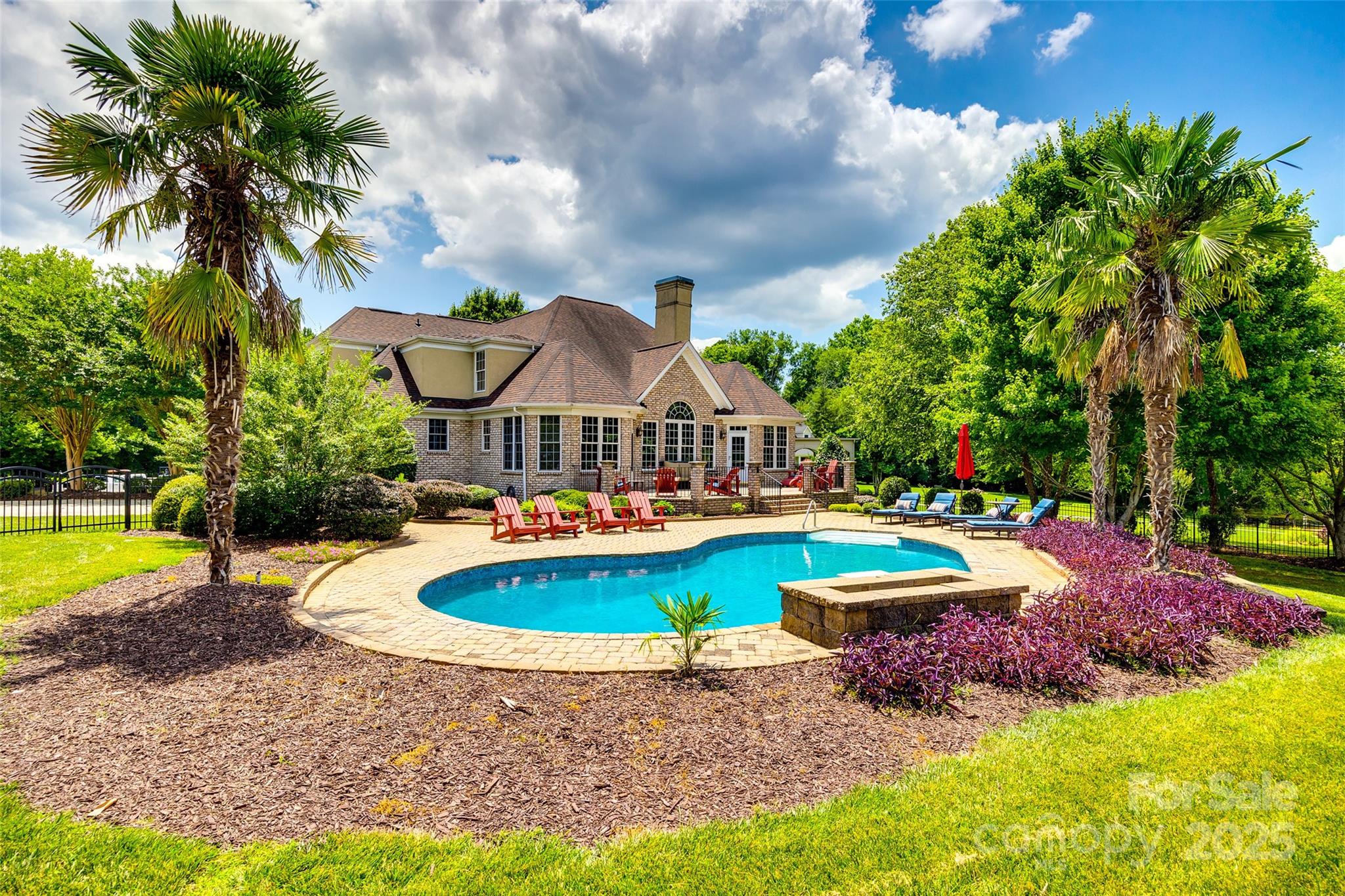 a view of a house with swimming pool and a yard