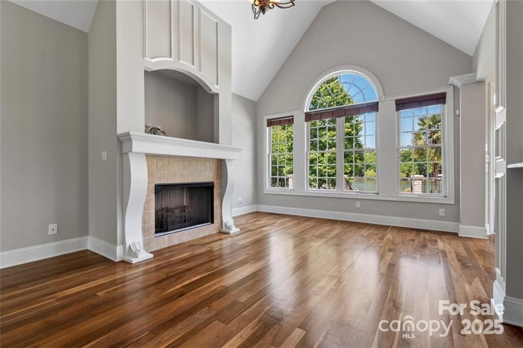 1765 Old Clay Hill Road York, SC 29745 - Photo 15 of 47 a view of an empty room with wooden floor a fireplace and a window