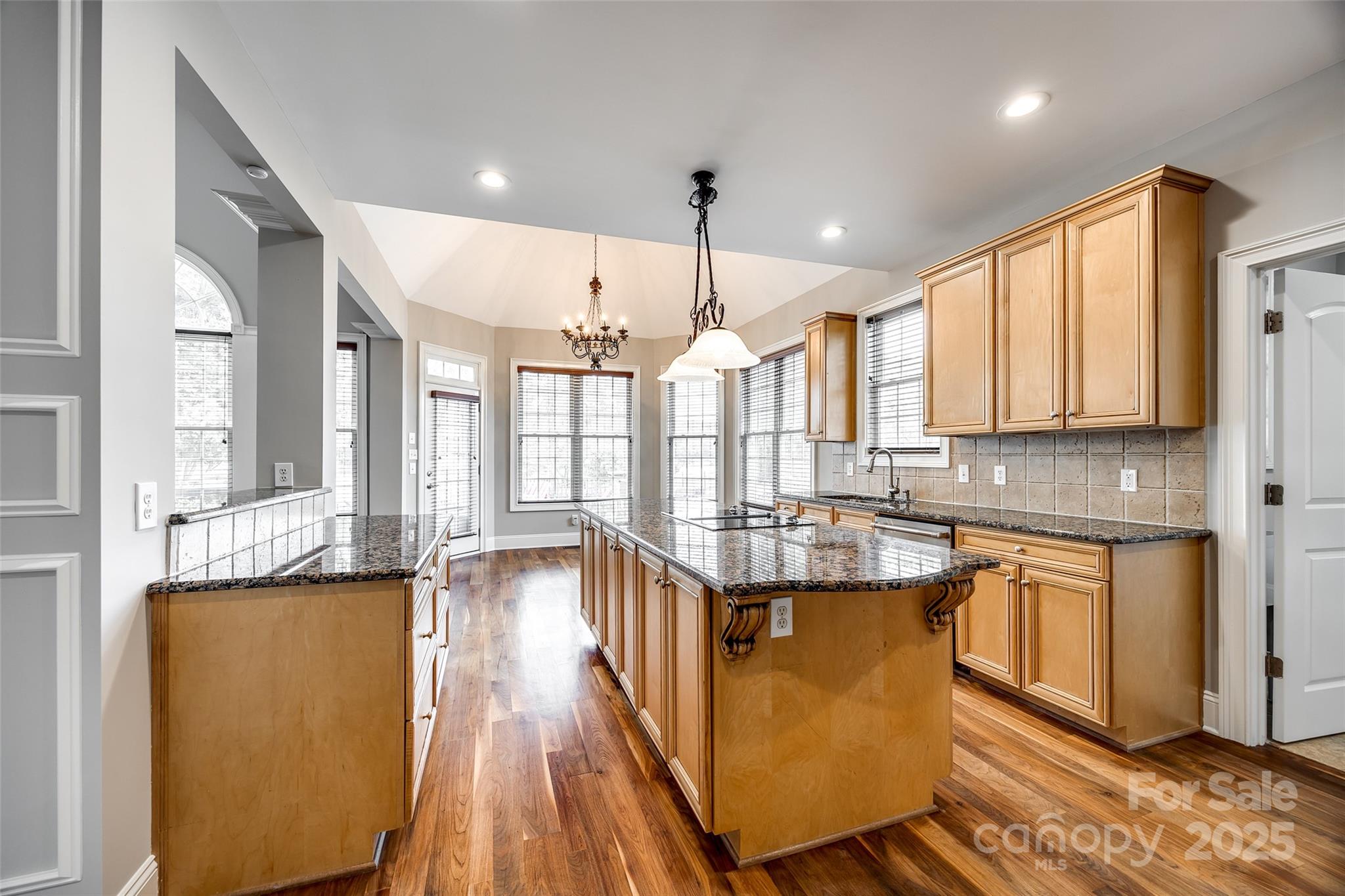 1765 Old Clay Hill Road York, SC 29745 - Photo 20 of 47 a kitchen with stainless steel appliances granite countertop a sink a stove and a wooden floors