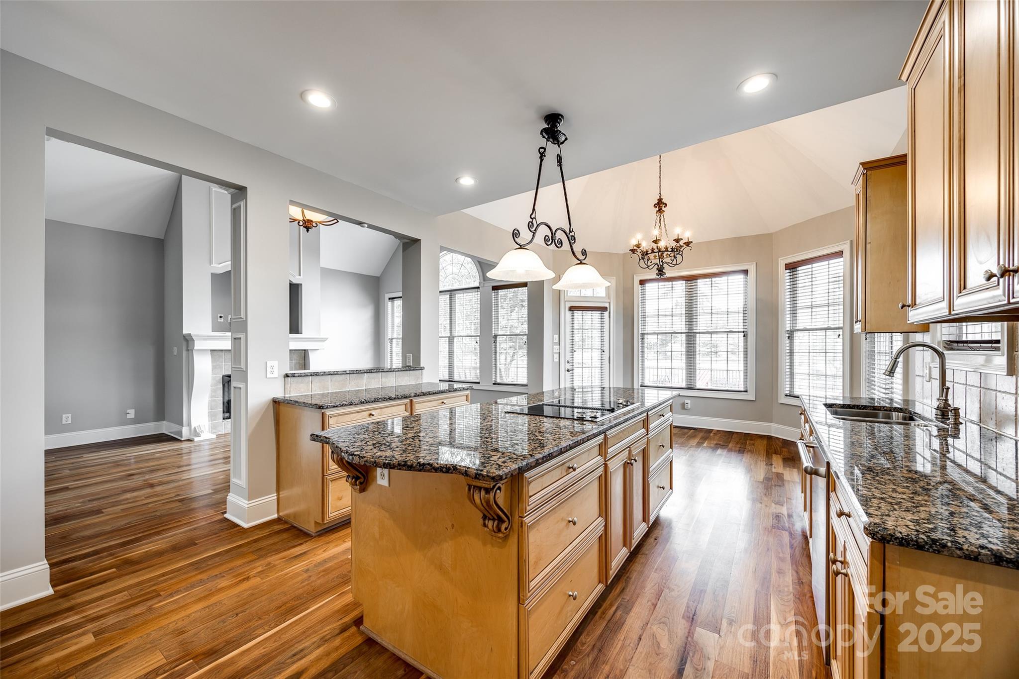 1765 Old Clay Hill Road York, SC 29745 - Photo 21 of 47 a dining hall with stainless steel appliances granite countertop a kitchen island a stove a sink a dining table and chairs with wooden floor