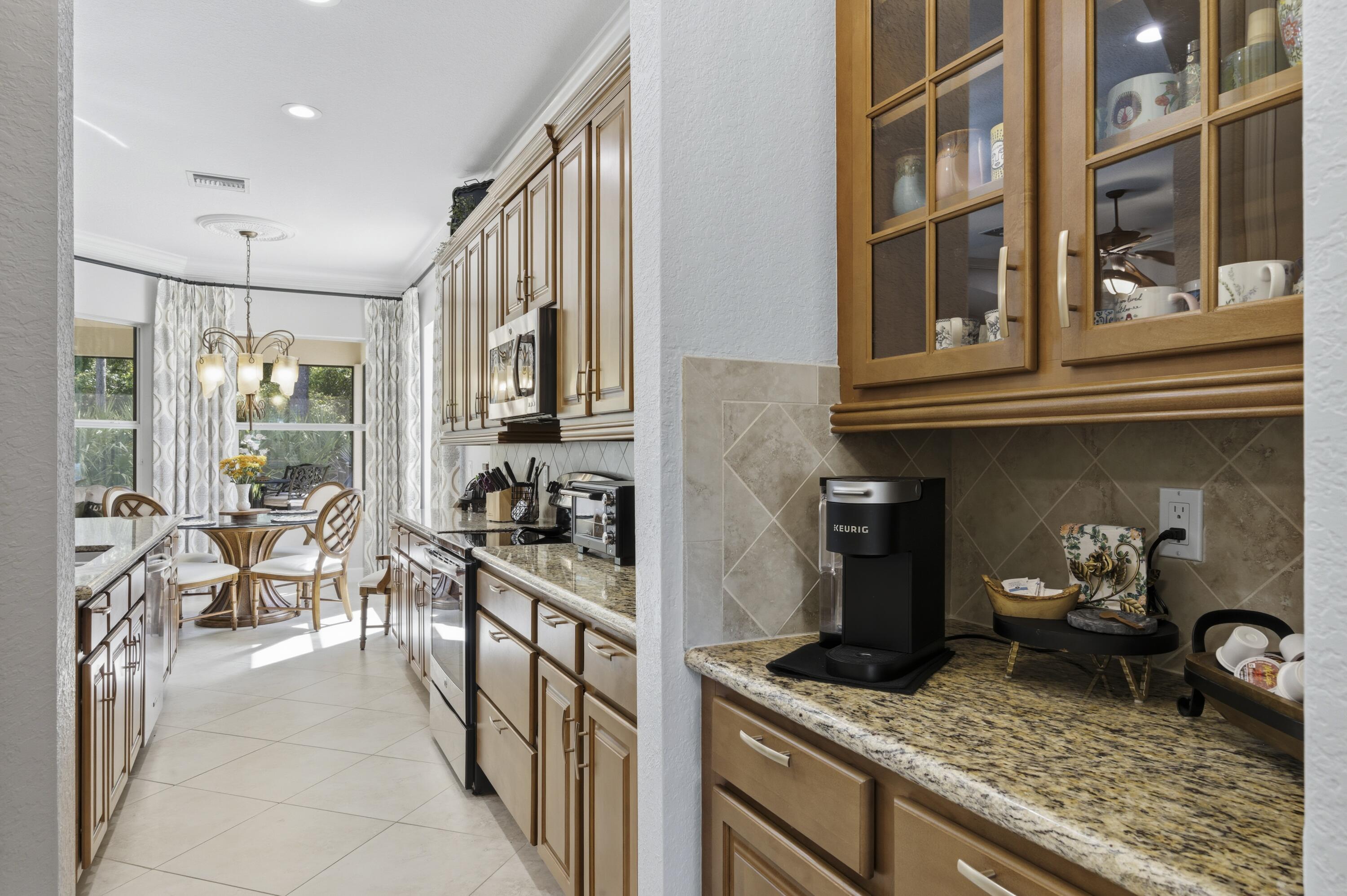 1016 Southwest Triste Way Stuart, FL 34997 - Photo 12 of 41 a kitchen with stainless steel appliances granite countertop a stove and cabinets