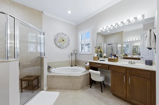 a spacious bathroom with a tub sink and mirror