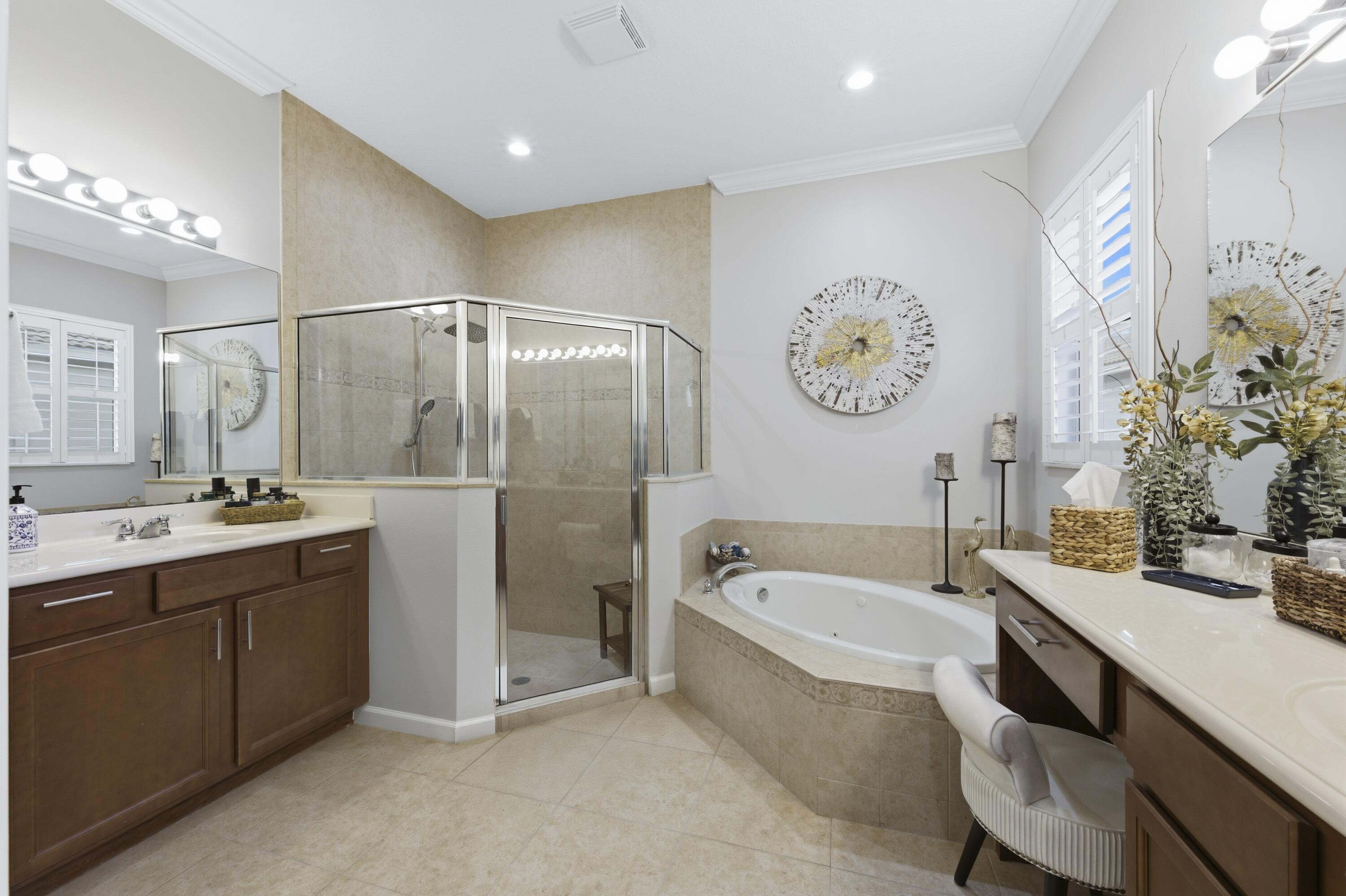 1016 Southwest Triste Way Stuart, FL 34997 - Photo 19 of 41 a spacious bathroom with a tub sink and mirror