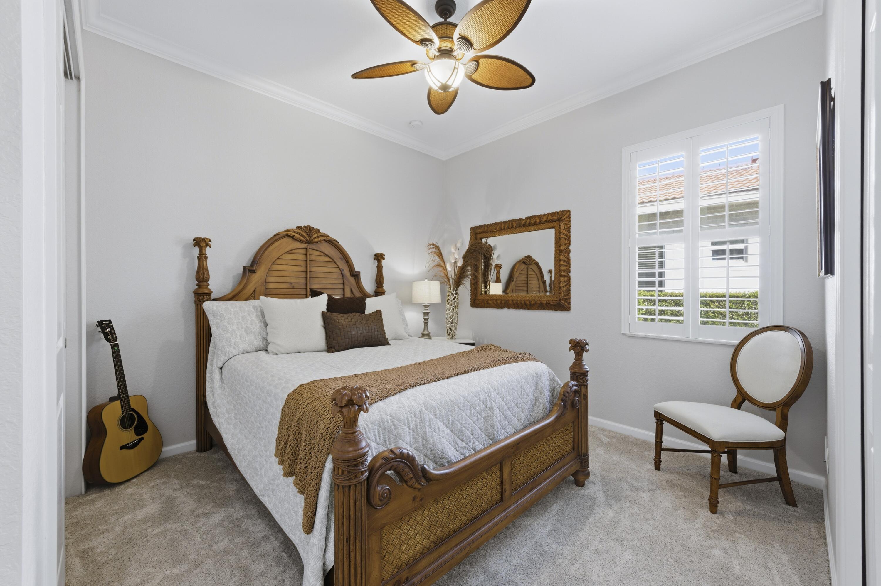1016 Southwest Triste Way Stuart, FL 34997 - Photo 20 of 41 a bedroom with a bed and a chandelier