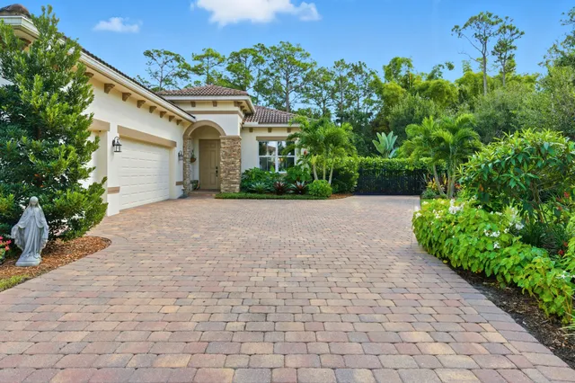 a front view of a house with a yard and a garage