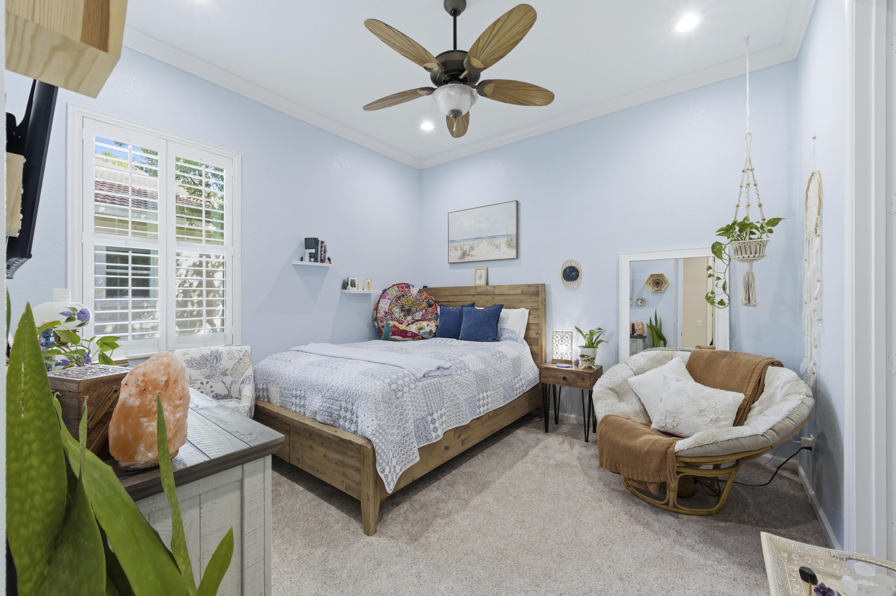 1016 Southwest Triste Way Stuart, FL 34997 - Photo 23 of 41 a bed room with a bed and a chair
