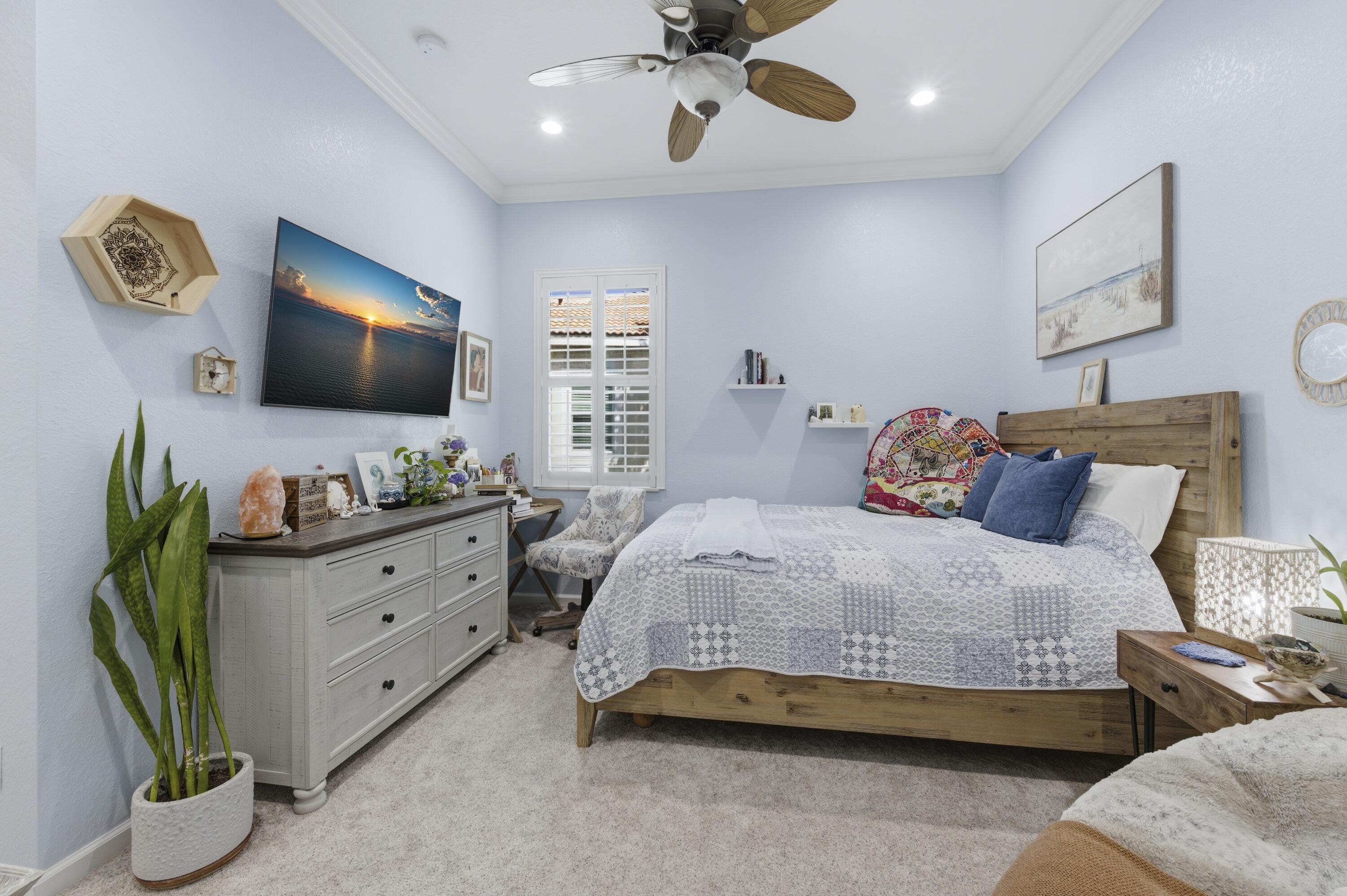 1016 Southwest Triste Way Stuart, FL 34997 - Photo 24 of 41 a bedroom with bed and a flat tv screen on dresser