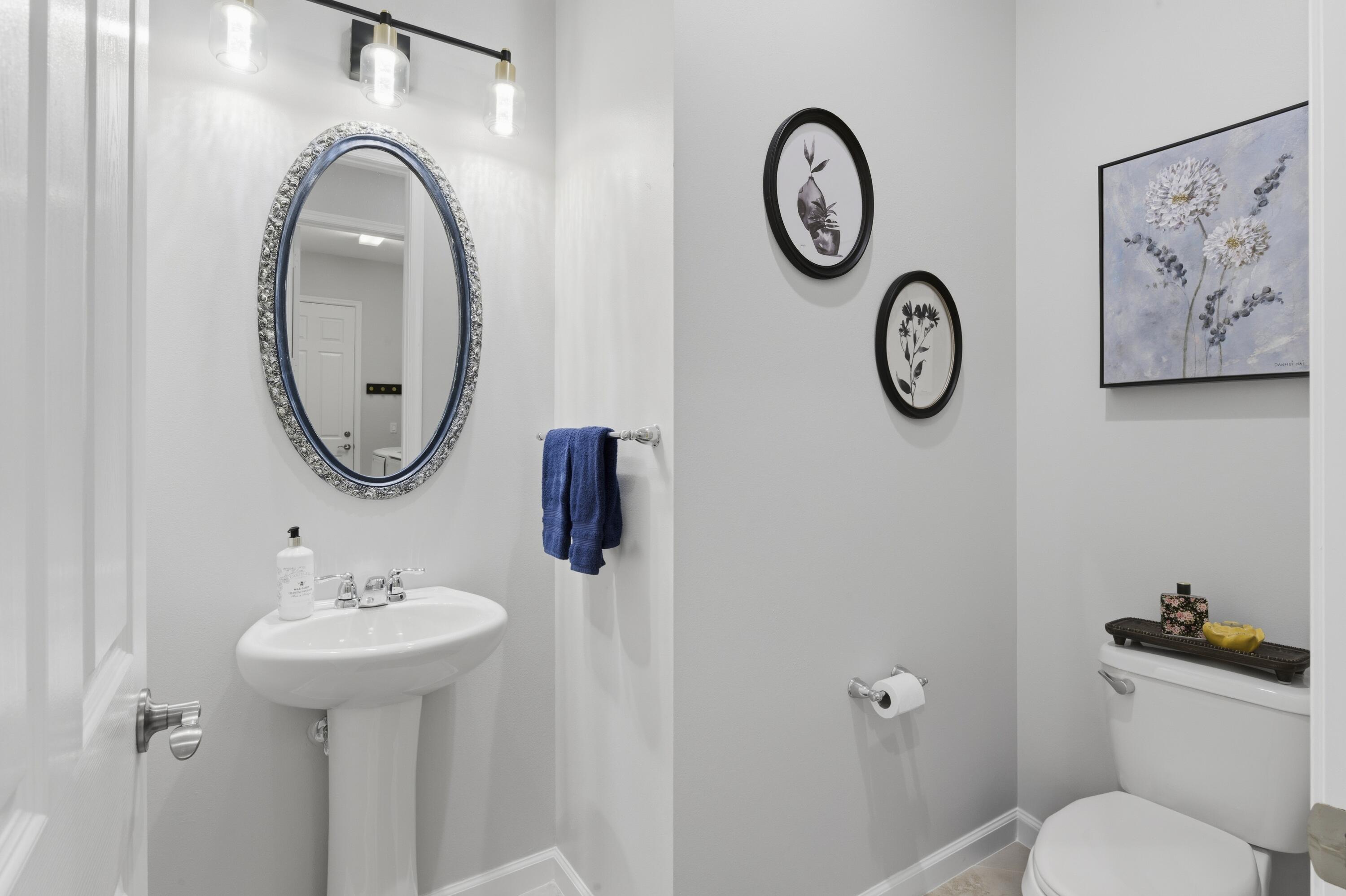 1016 Southwest Triste Way Stuart, FL 34997 - Photo 26 of 41 a bathroom with a toilet sink and mirror