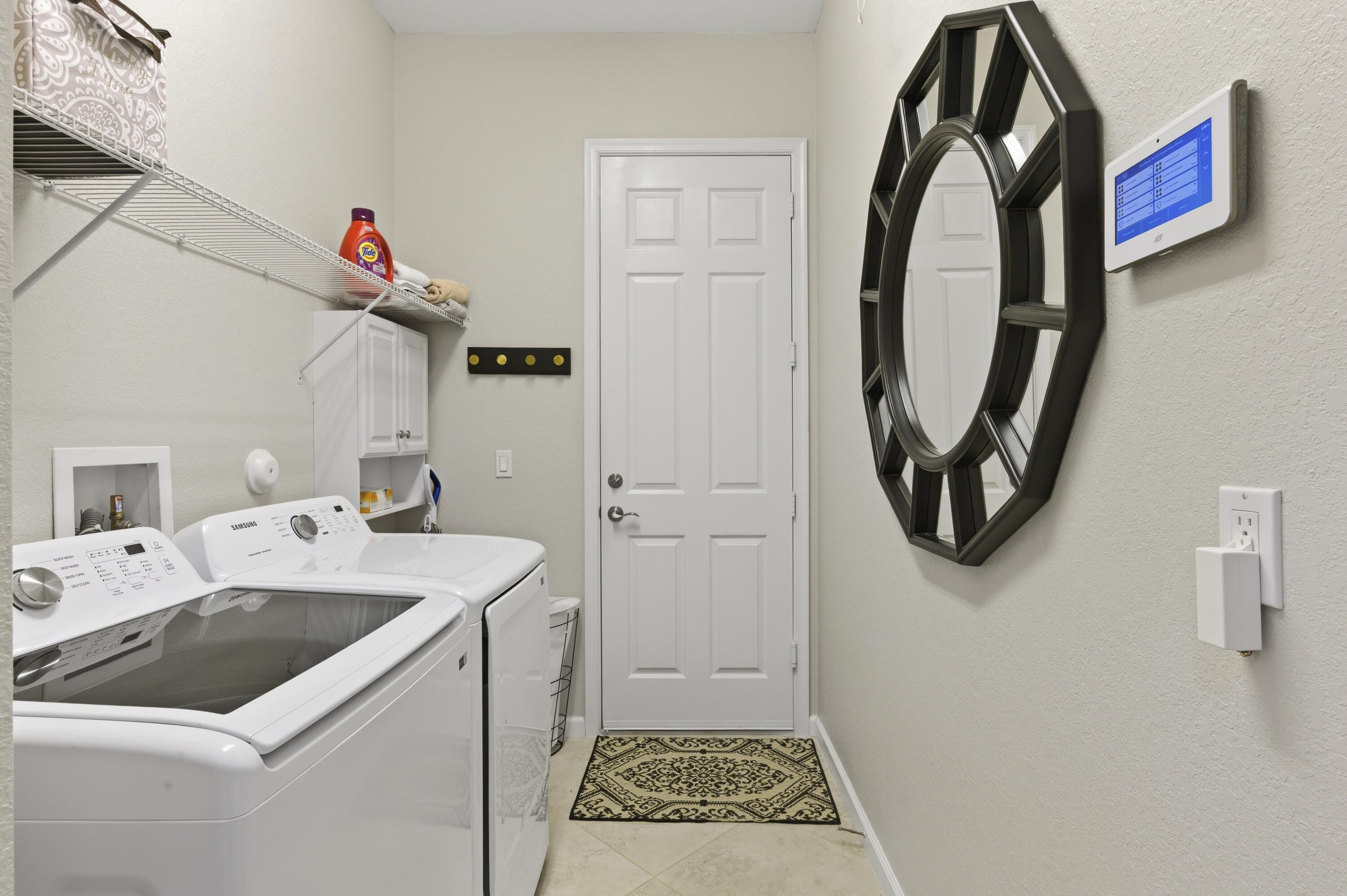 1016 Southwest Triste Way Stuart, FL 34997 - Photo 27 of 41 a utility room with dryer and washer