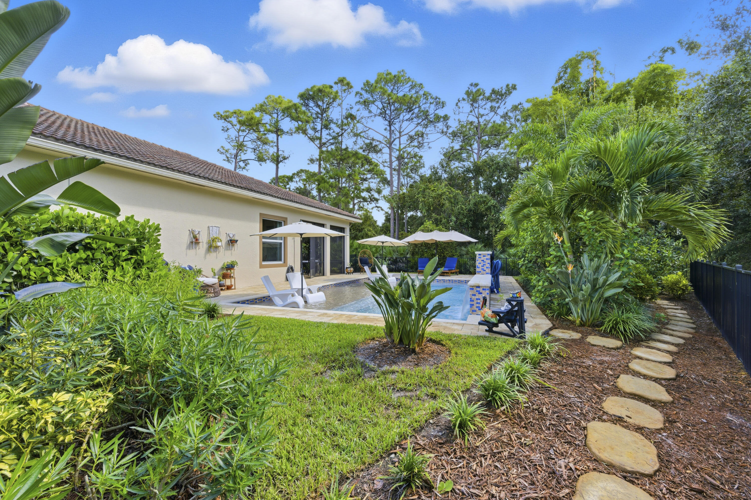 1016 Southwest Triste Way Stuart, FL 34997 - Photo 32 of 41 a front view of a house with garden