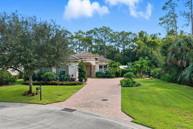 an aerial view of a house with a yard and garden