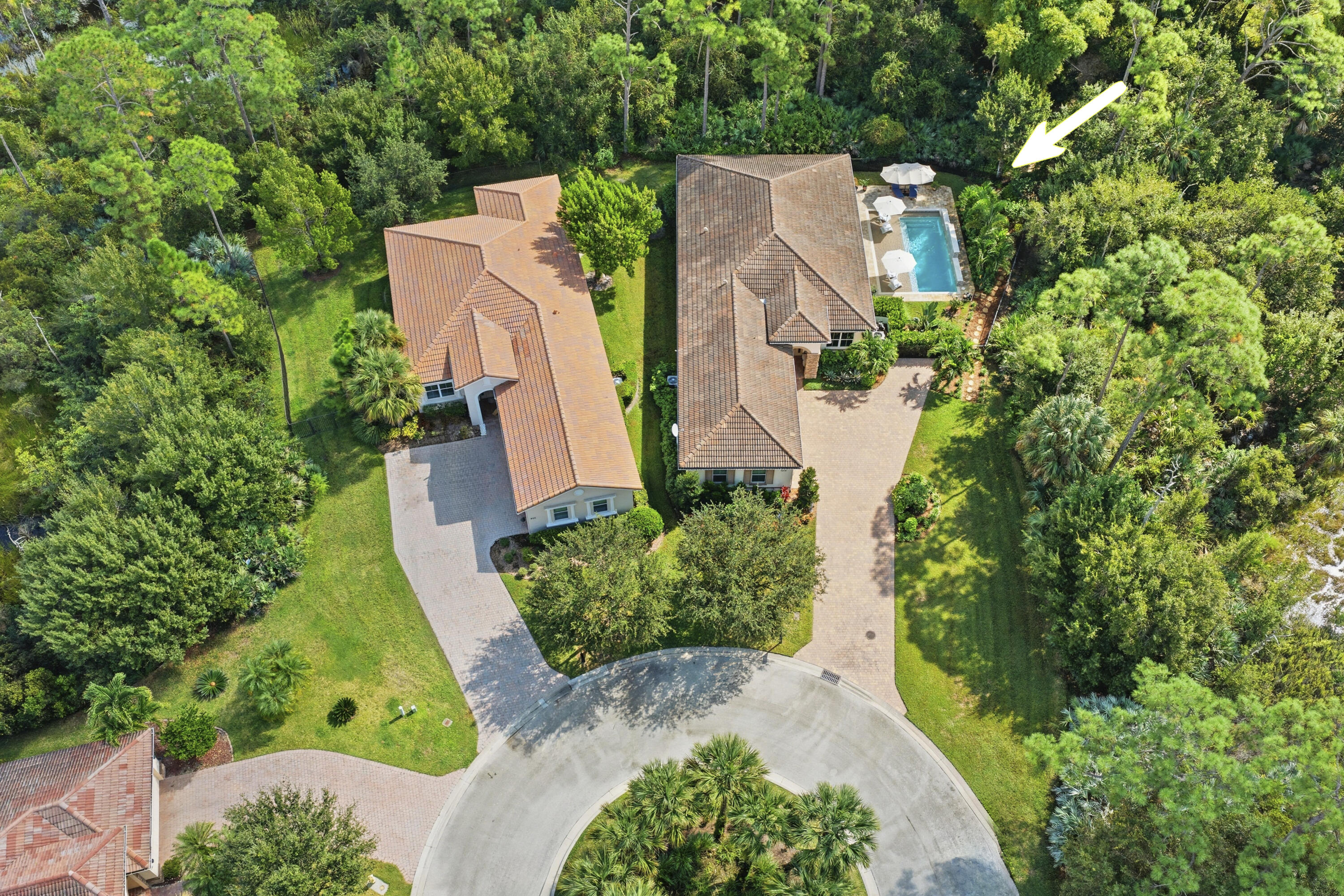 1016 Southwest Triste Way Stuart, FL 34997 - Photo 35 of 41 an aerial view of a house with a yard and garden