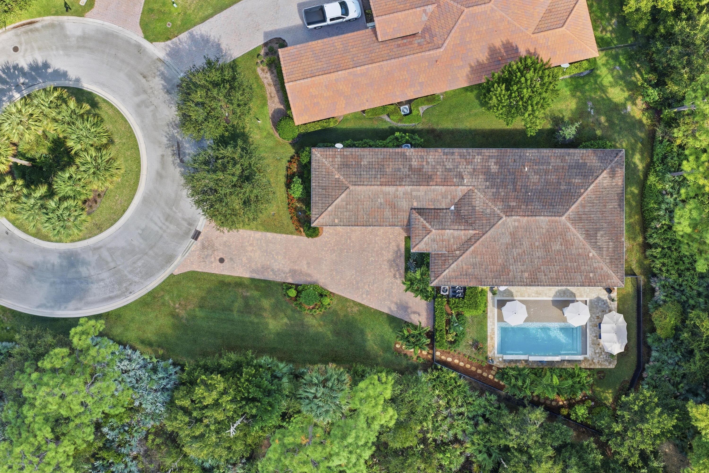 1016 Southwest Triste Way Stuart, FL 34997 - Photo 36 of 41 an aerial view of a house with garden space and a patio
