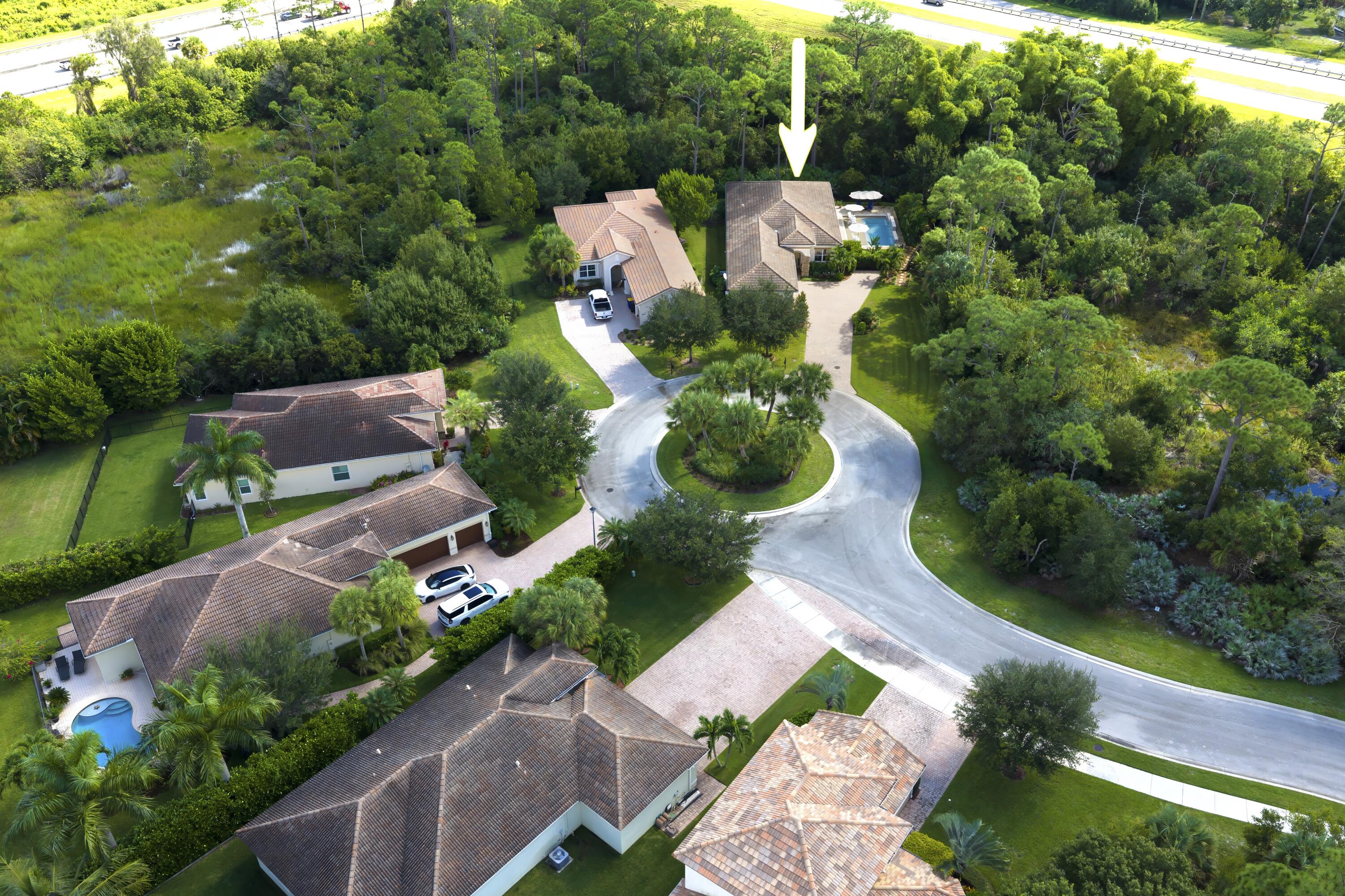 1016 Southwest Triste Way Stuart, FL 34997 - Photo 37 of 41 an aerial view of a house with yard swimming pool and outdoor seating