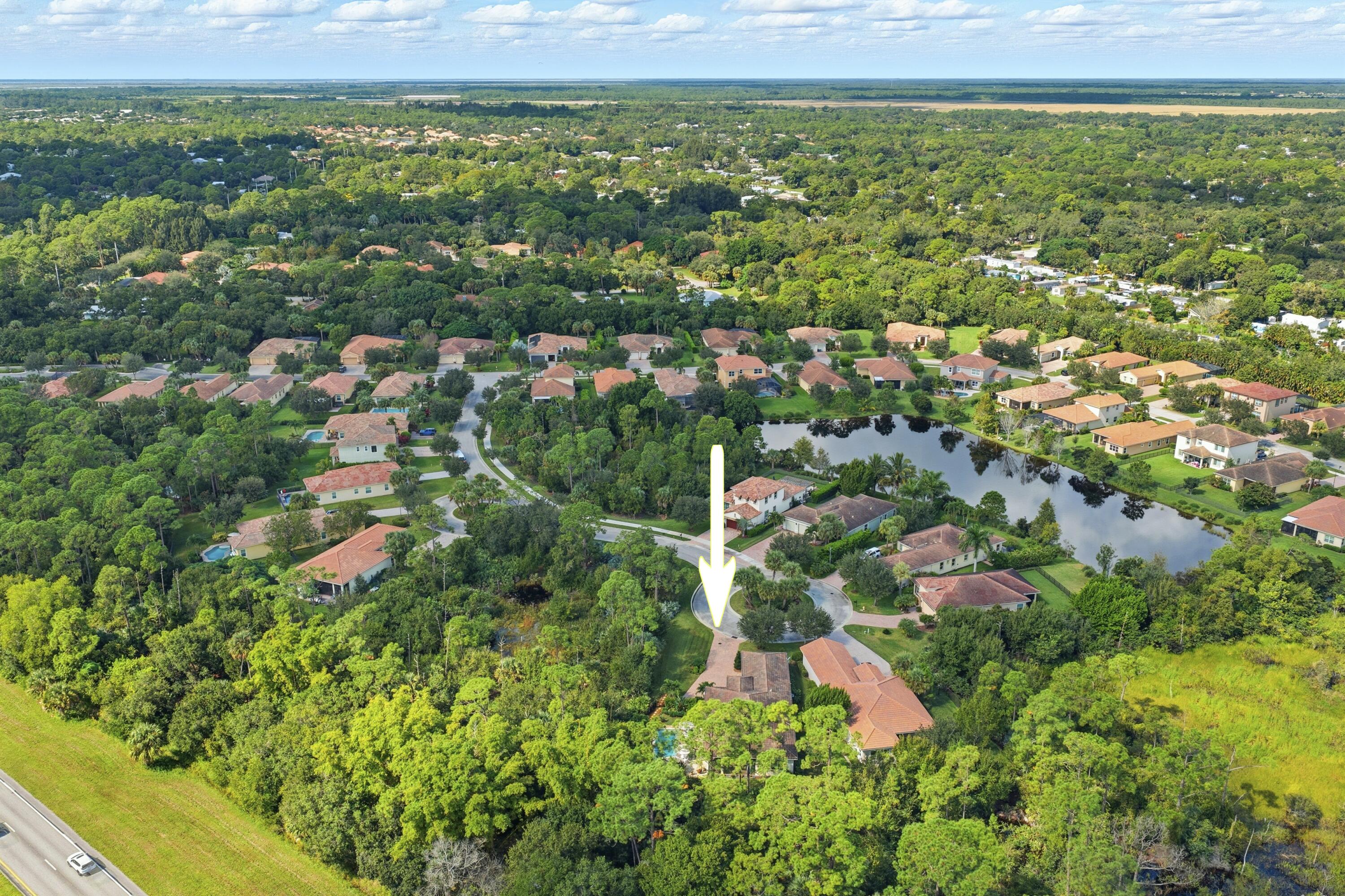 1016 Southwest Triste Way Stuart, FL 34997 - Photo 39 of 41 an aerial view of residential houses with outdoor space and trees