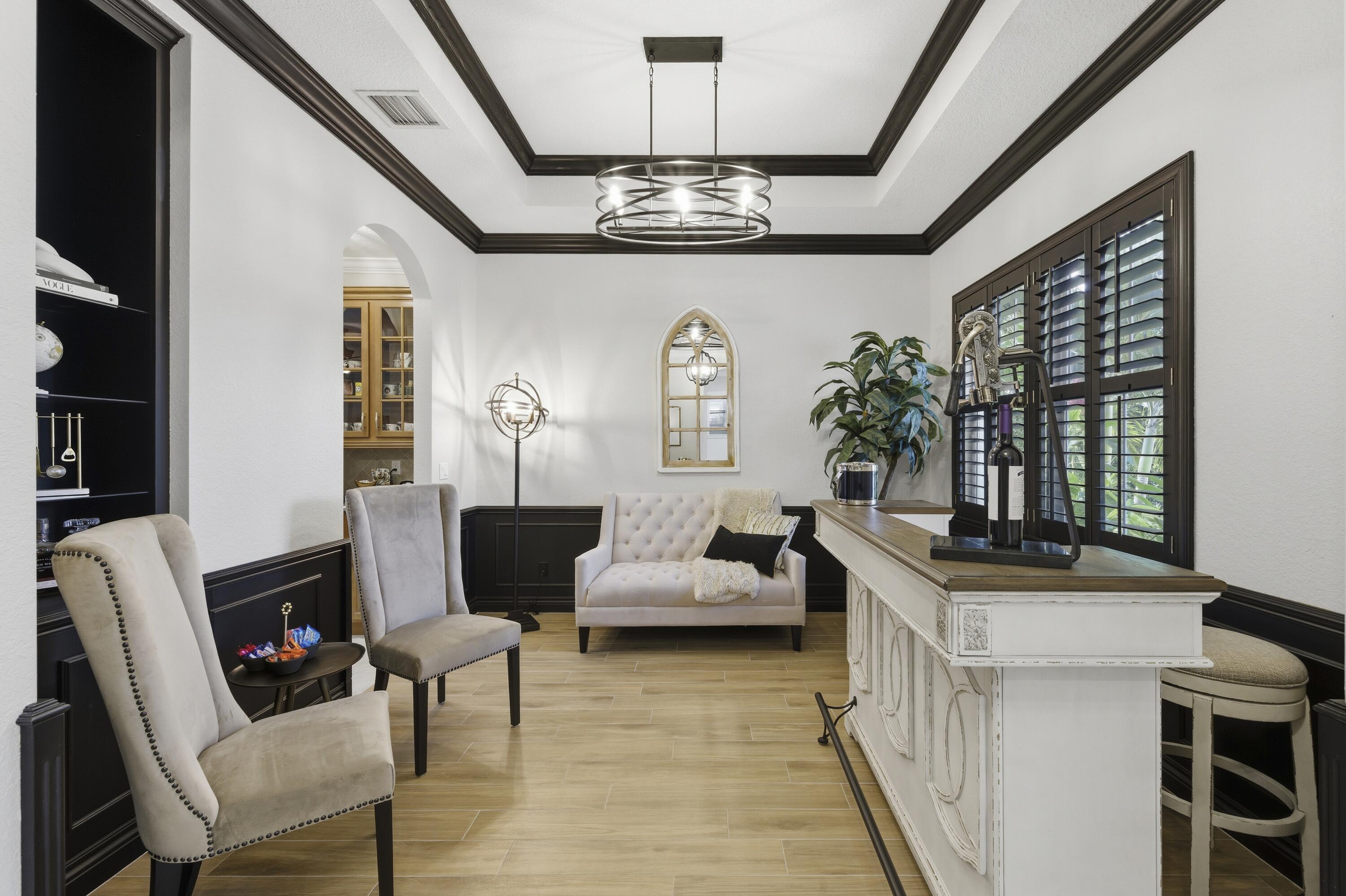 1016 Southwest Triste Way Stuart, FL 34997 - Photo 7 of 41 a living room with furniture and chandelier