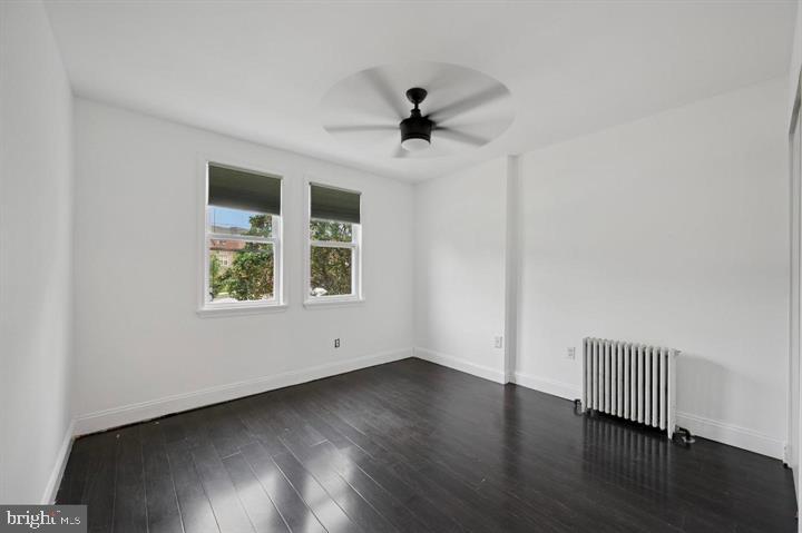 2467 79th Avenue, Unit 1 Philadelphia, PA 19150 - Photo 8 of 16 an empty room with wooden floor chandelier fan and windows