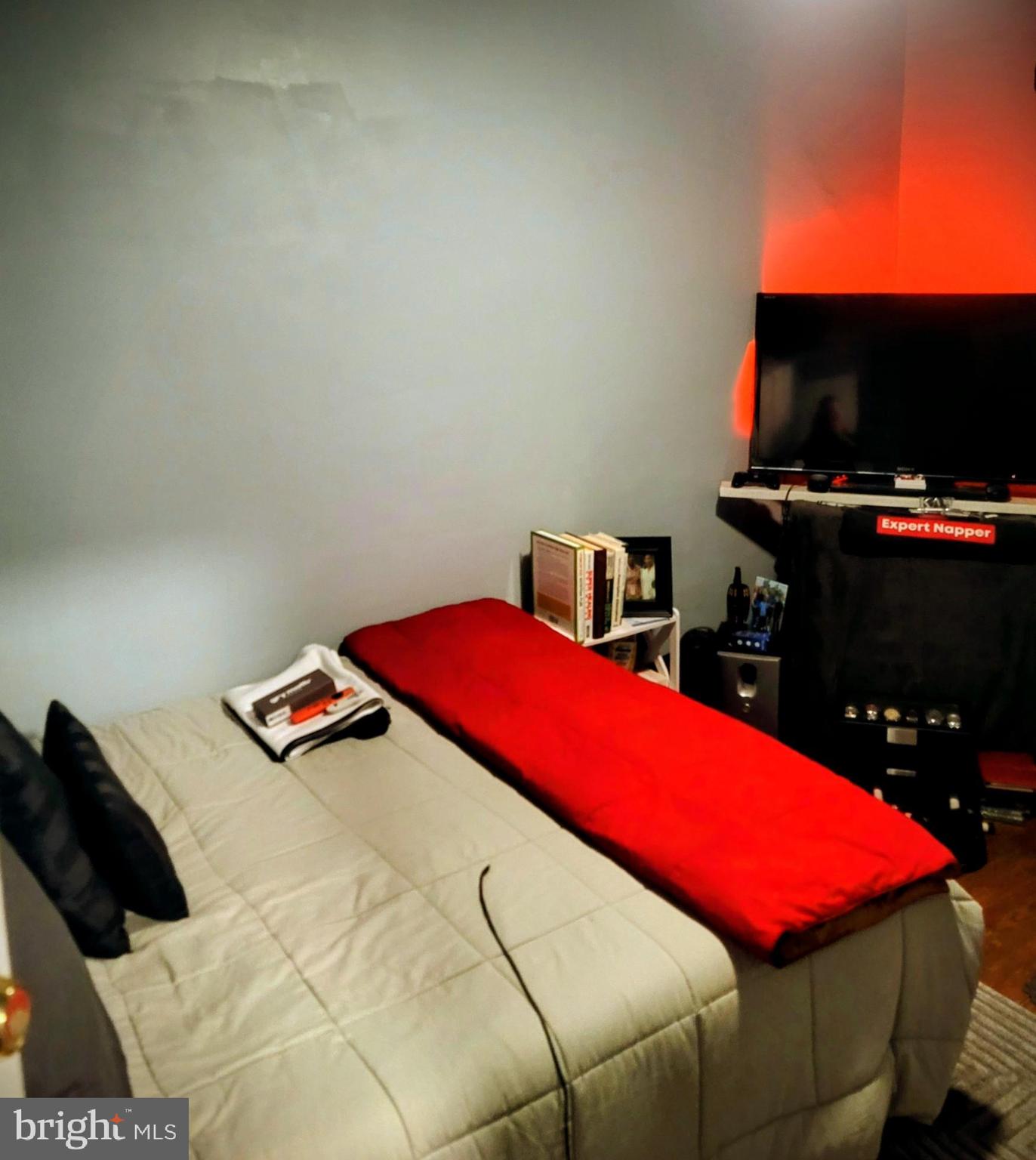 6138 Wayne Avenue, Unit 2 Philadelphia, PA 19144 - Photo 12 of 22 a bedroom with a bed and a flat screen tv