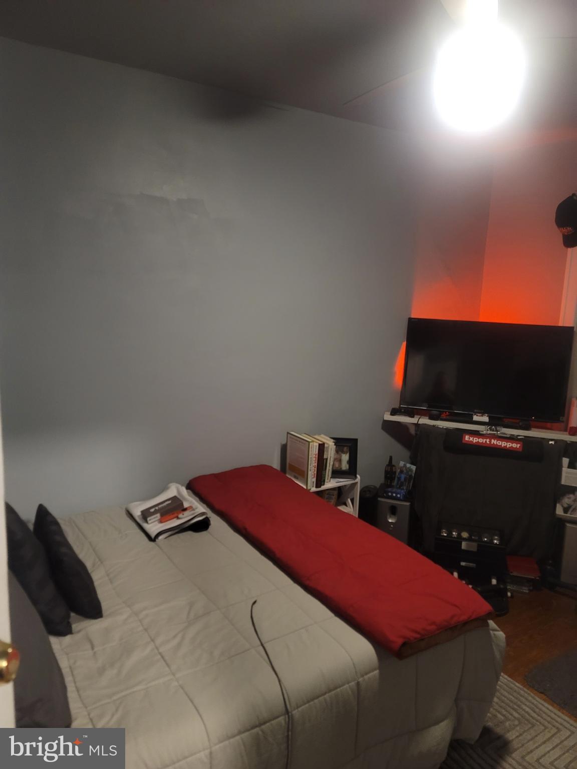 6138 Wayne Avenue, Unit 2 Philadelphia, PA 19144 - Photo 21 of 22 a bedroom with a bed and a flat screen tv