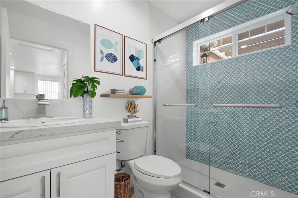 14243 Magnolia Boulevard Sherman Oaks, CA 91423 - Photo 3 of 8 a bathroom with a toilet sink and mirror