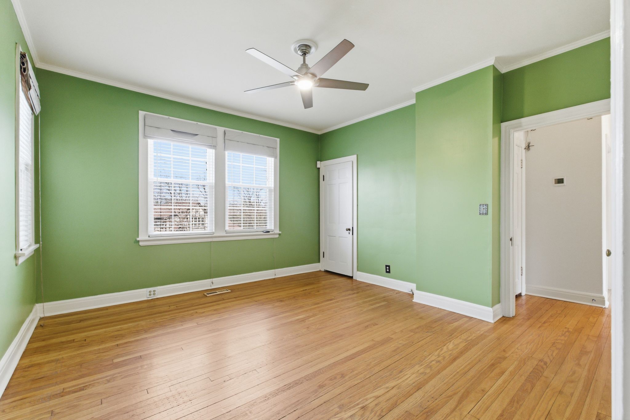1002 Sutton Hill Road Nashville, TN 37204 - Photo 11 of 34 wooden floor in an empty room with a window