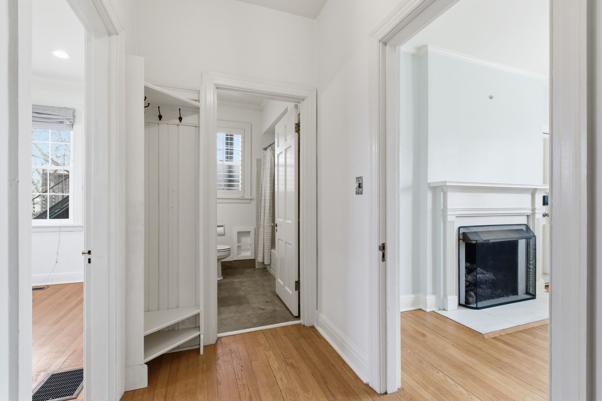 1002 Sutton Hill Road Nashville, TN 37204 - Photo 13 of 34 a view of a hallway with wooden floor and a living room