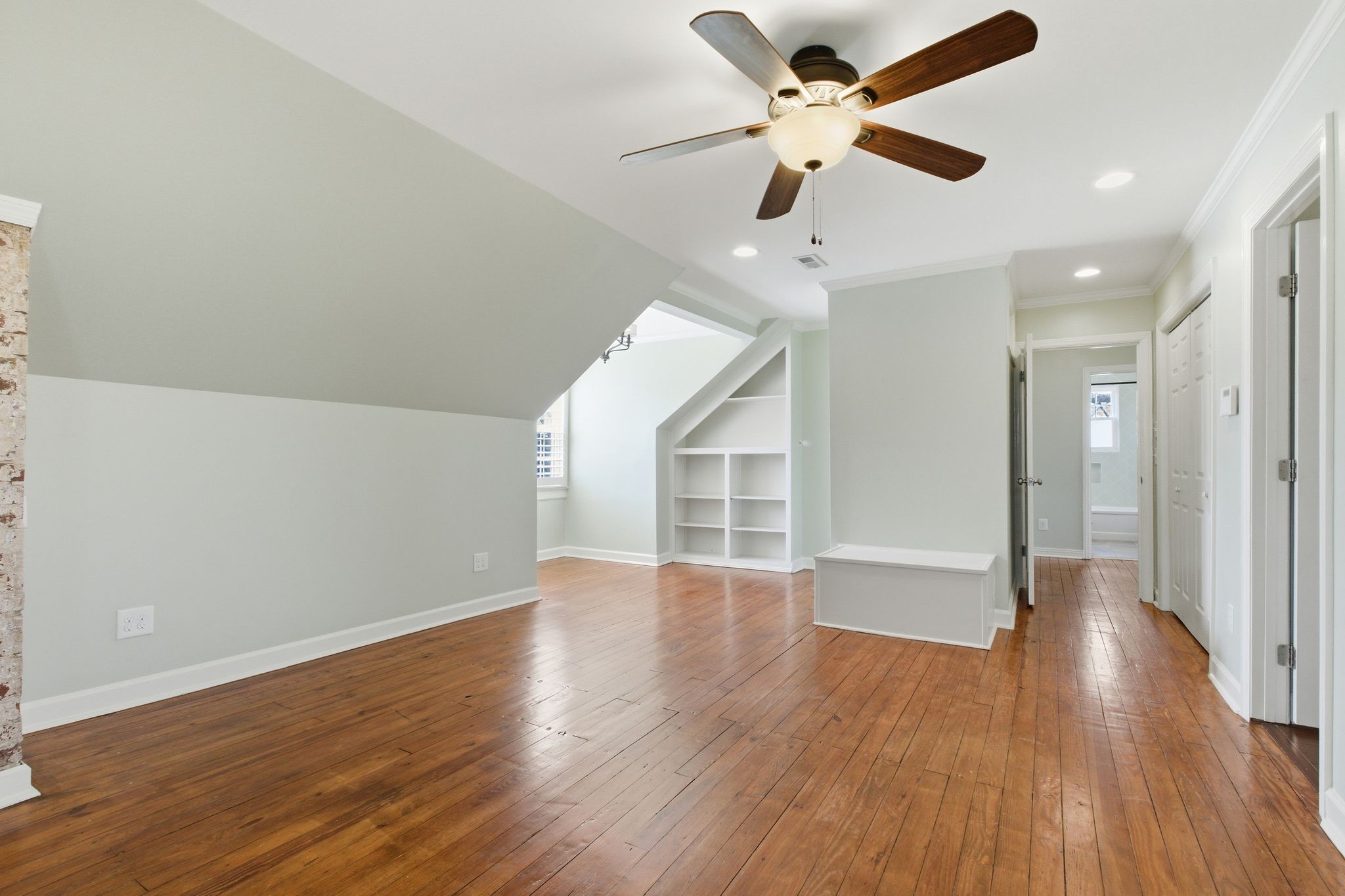 1002 Sutton Hill Road Nashville, TN 37204 - Photo 17 of 34 a view of an empty room with wooden floor and a ceiling fan