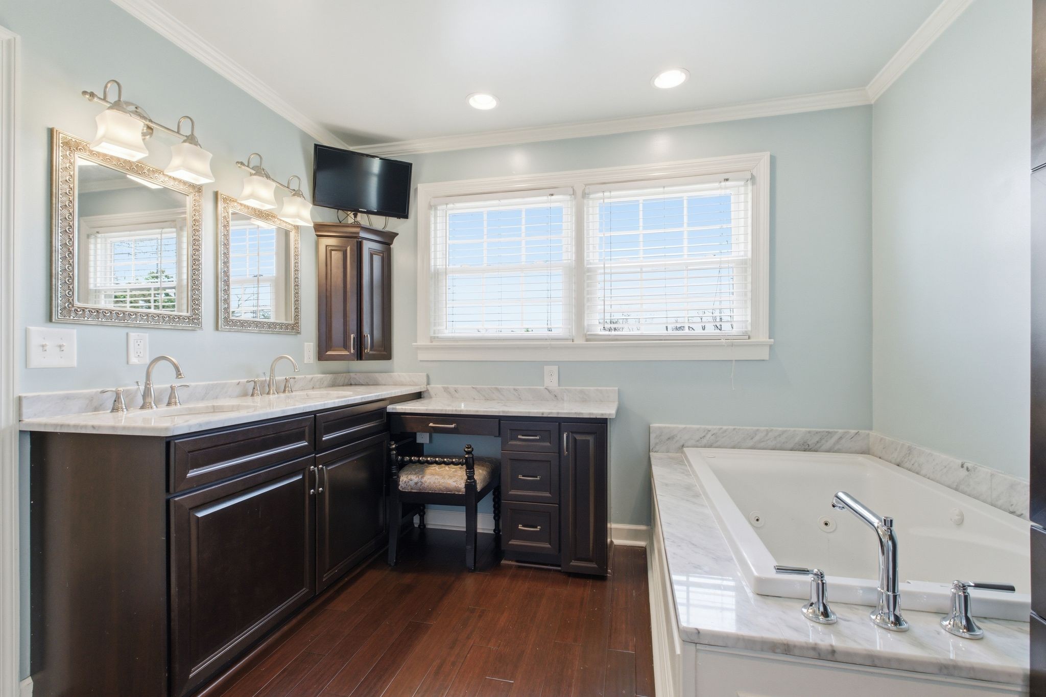 1002 Sutton Hill Road Nashville, TN 37204 - Photo 18 of 34 a spacious bathroom with a granite countertop sink a mirror and a bathtub