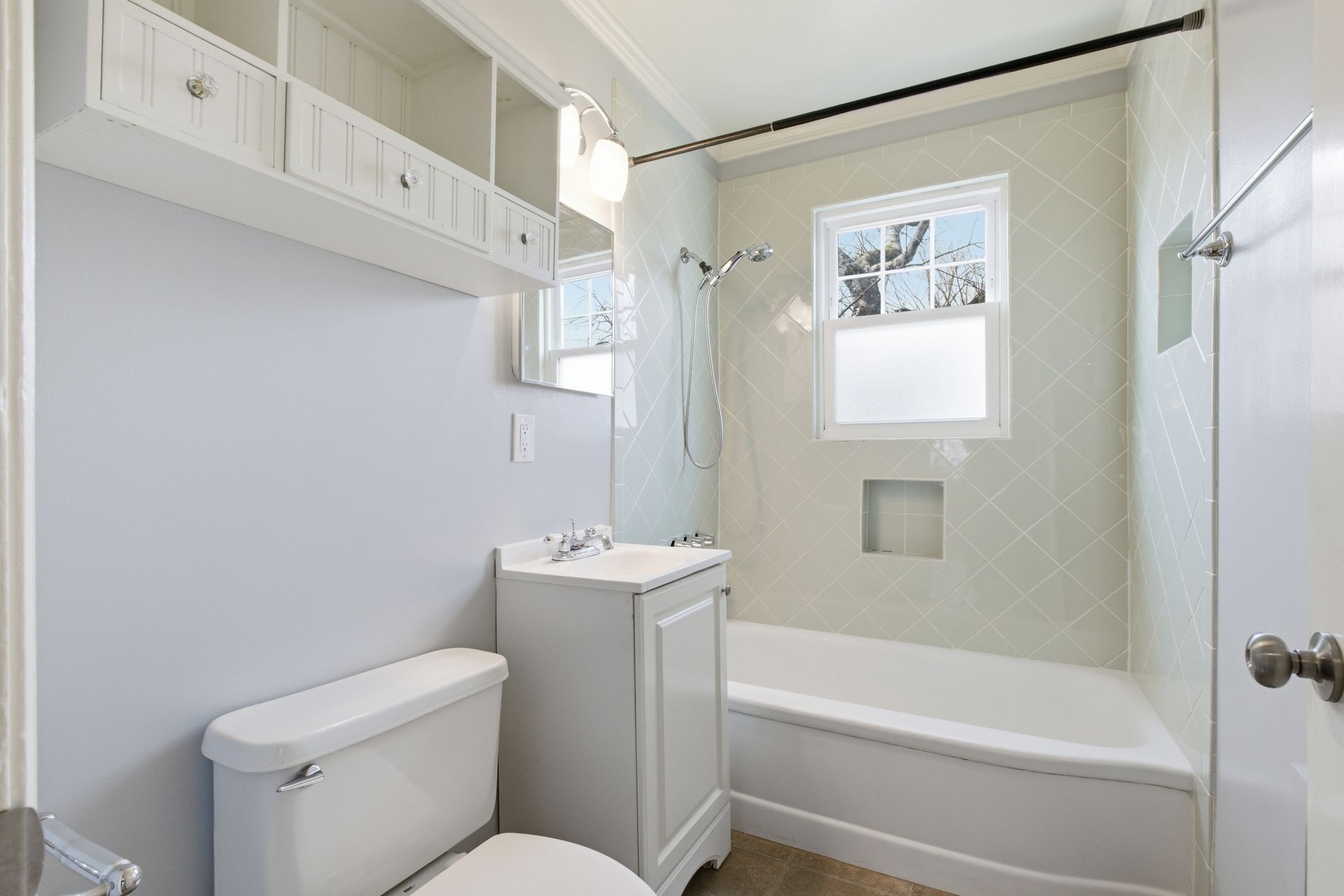1002 Sutton Hill Road Nashville, TN 37204 - Photo 23 of 34 a bathroom with a toilet and a bathtub