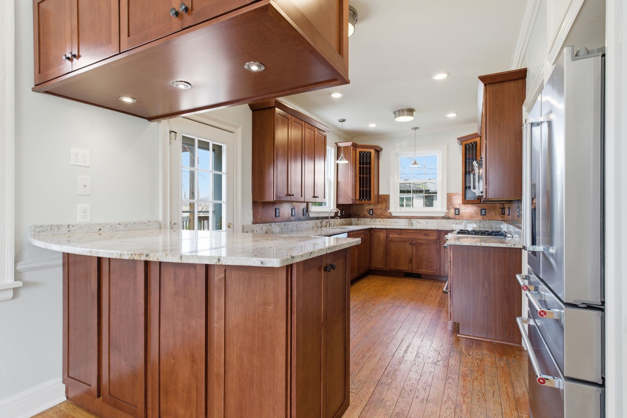 1002 Sutton Hill Road Nashville, TN 37204 - Photo 7 of 34 a kitchen with stainless steel appliances granite countertop a sink refrigerator and cabinets