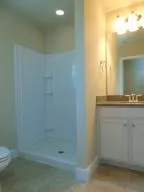 a bathroom with a toilet and a shower