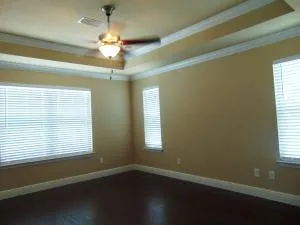 a view of a room with wooden floors and a window