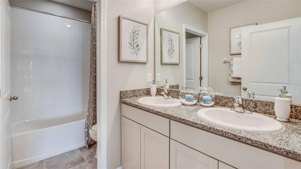 1909 Cobb Trail Parrish, FL 34219 - Photo 15 of 15 a bathroom with a granite countertop sink and a mirror