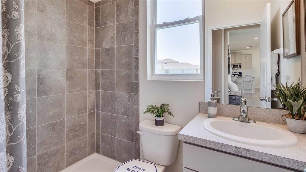 1909 Cobb Trail Parrish, FL 34219 - Photo 8 of 15 a bathroom with a sink toilet a mirror and shower