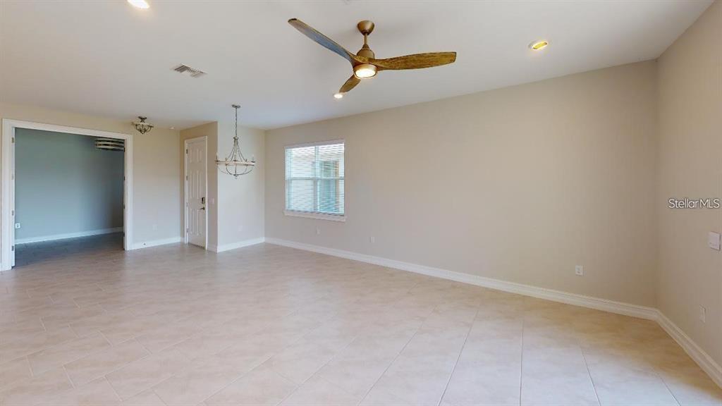 127 Ibiza Loop Venice, FL 34292 - Photo 8 of 20 an empty room with ceiling fan and window