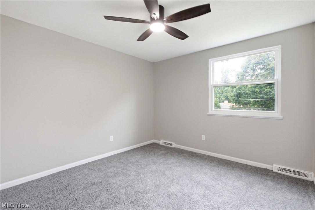 7012 Roe Boulevard Madison, OH 44057 - Photo 21 of 30 Recessed lighting, ceiling fan with integrated light, light gray wall paint, white trim, and gray carpeting