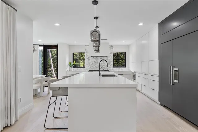a bedroom with a large bed and a chandelier