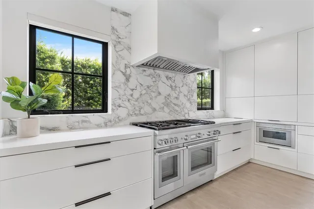 a spacious bedroom with a bed and a large window