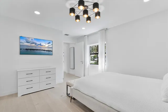 a bedroom with furniture and a window