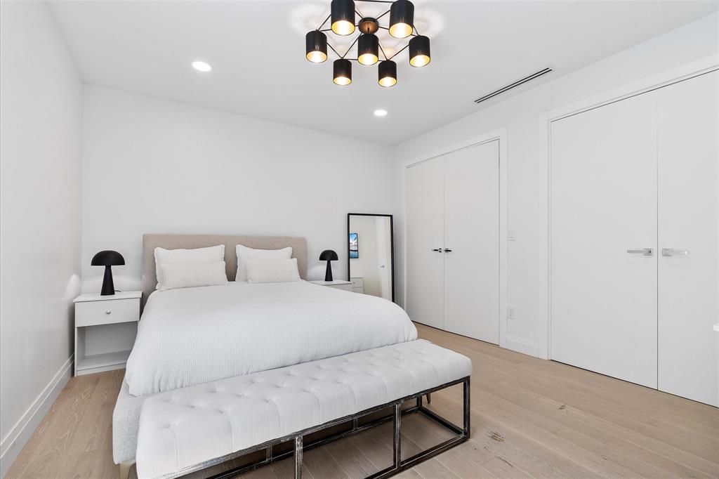 9 Tahoe Lane Sea Ranch Lakes, FL 33308 - Photo 34 of 99 a bedroom with a large bed and a chandelier