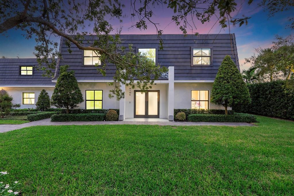 9 Tahoe Lane Sea Ranch Lakes, FL 33308 - Photo 4 of 99 a front view of a house with a garden