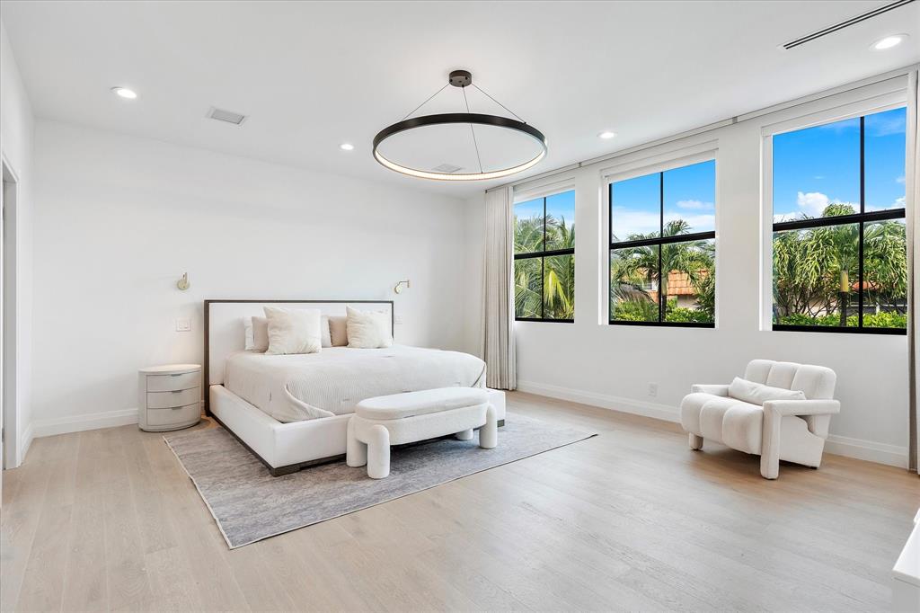 9 Tahoe Lane Sea Ranch Lakes, FL 33308 - Photo 41 of 99 a spacious bedroom with a bed and a large window