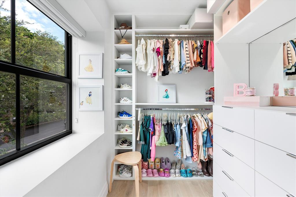 9 Tahoe Lane Sea Ranch Lakes, FL 33308 - Photo 57 of 99 a view of a walk in closet with clothes shoes and a large mirror
