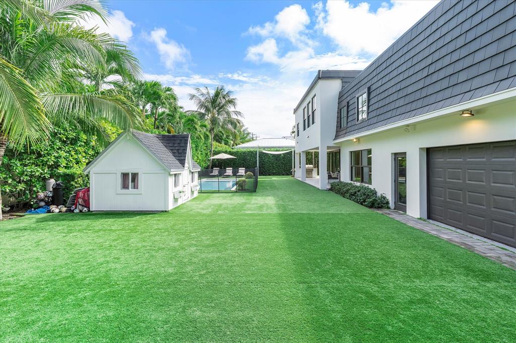 9 Tahoe Lane Sea Ranch Lakes, FL 33308 - Photo 64 of 99 a view of a house with a yard and a garden