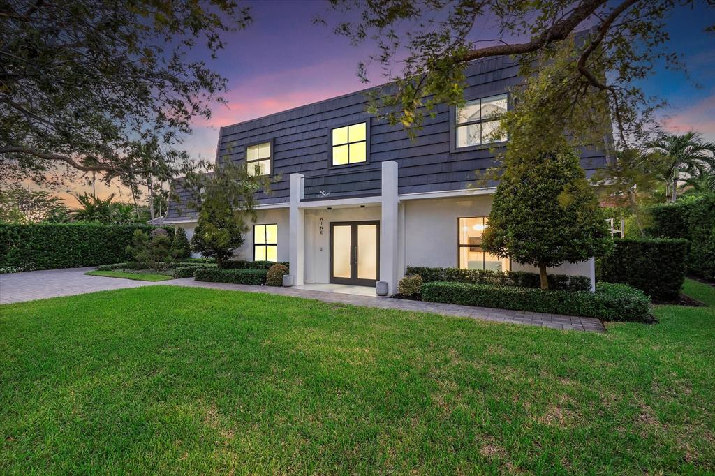 9 Tahoe Lane Sea Ranch Lakes, FL 33308 - Photo 75 of 99 a large brick building with a big yard and large trees
