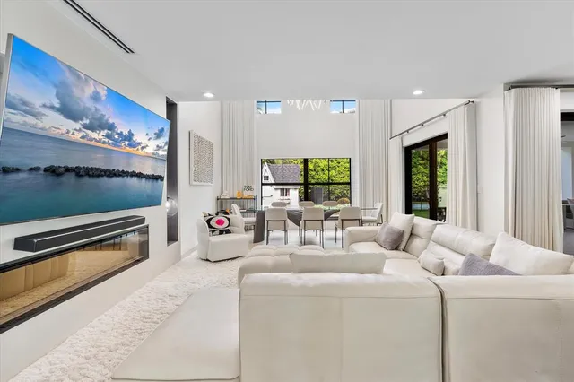 a living room with furniture and a view of kitchen