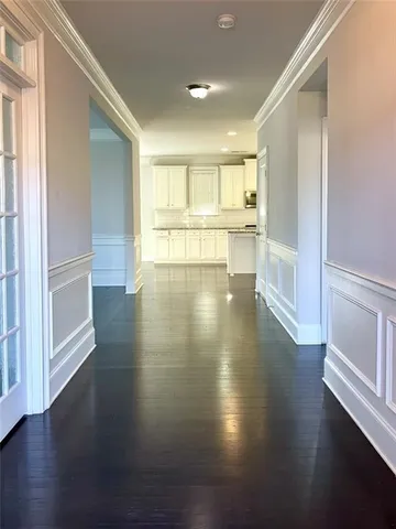 a view of a kitchen with wooden floor and stainless steel appliances