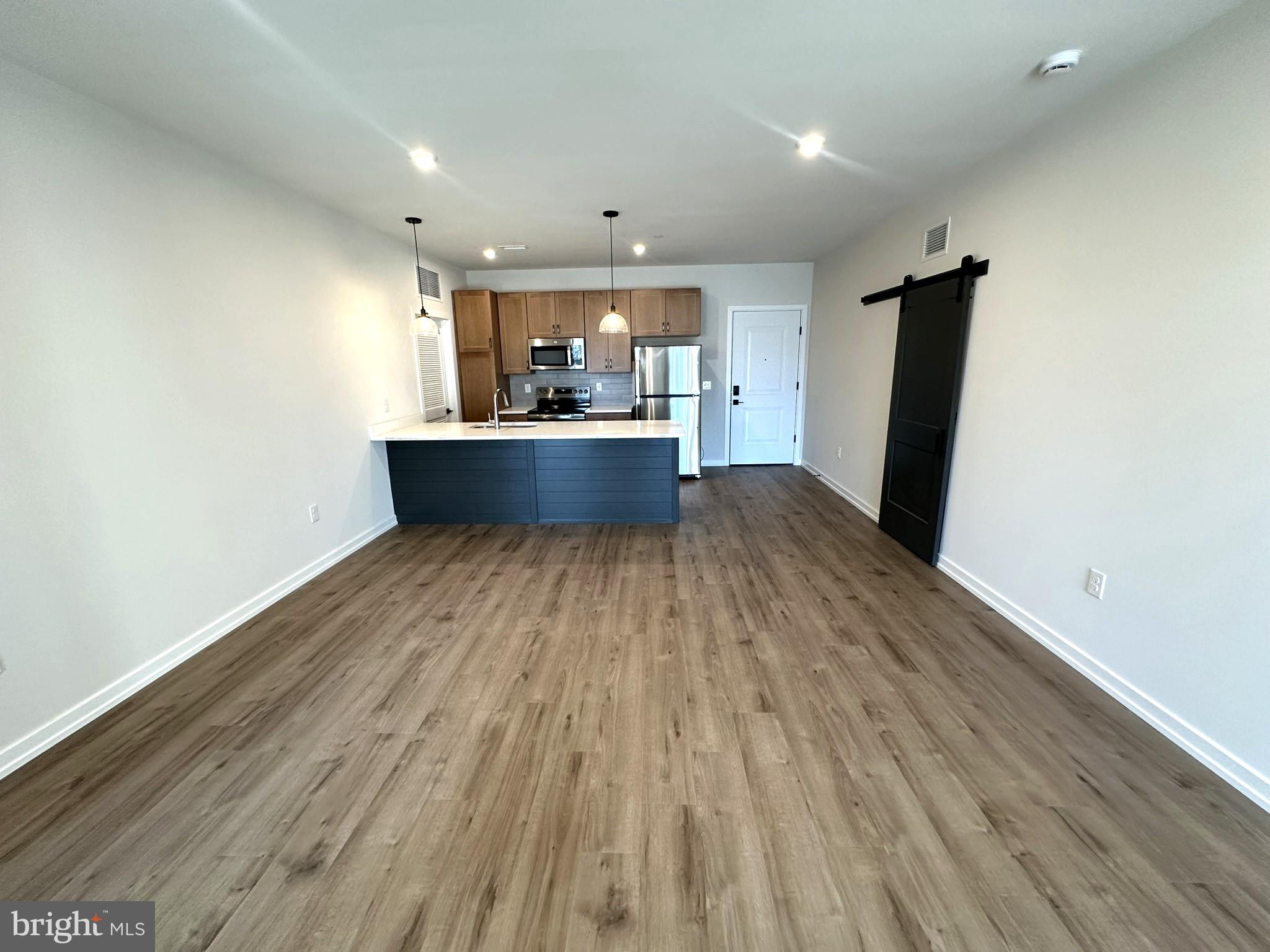 409 West Butler Avenue, Unit 223 Chalfont, PA 18914 - Photo 1 of 33 an empty room with wooden floor and outdoor view