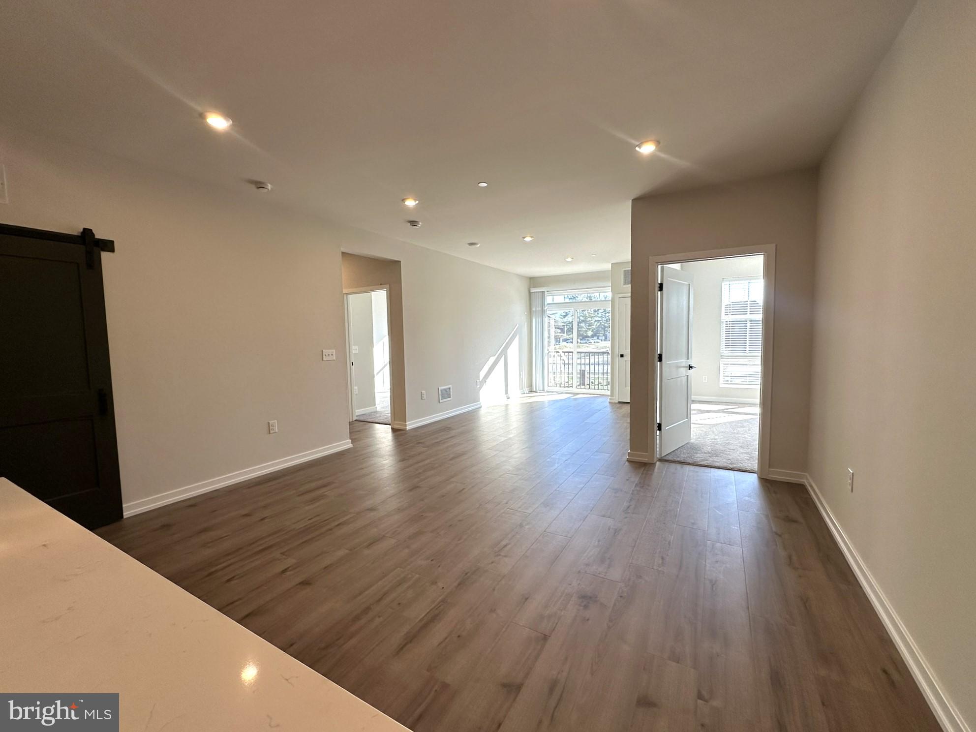 409 West Butler Avenue, Unit 223 Chalfont, PA 18914 - Photo 11 of 33 a view of an empty room with wooden floor and a window